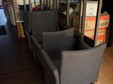 two chairs that are sitting in front of a glass wall