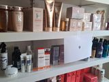 a shelf that has many different types of beauty products on it