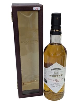 a bottle of scotch whisky sitting next to a cardboard box