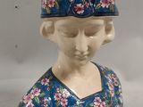 porcelain figurine of a woman wearing a blue dress and a crown
