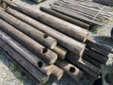a pile of wood sitting on the ground next to a pile of logs