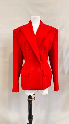 red jacket on a mannequin stand on a white background