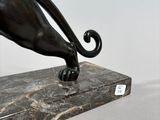 bronze sculpture of a cat on a marble base
