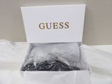 a white box with a bunch of black and gold items in it
