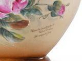 a vase with a painting of a pink rose on it