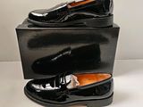 a pair of black shoes sitting on top of a box