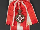 an old red and white ribbon with a star on it