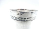 a close up of a silver cup on a table