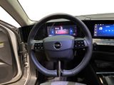 the interior of a car with a steering wheel and dashboard controls