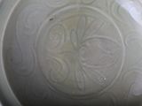 a white bowl with a design on it on a table