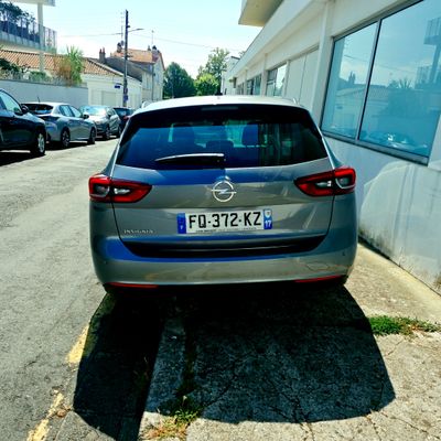 a silver car parked on the side of the road