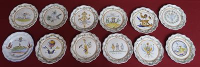 many plates with pictures of people on them on a red surface