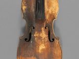 a close up of a violin on a gray surface