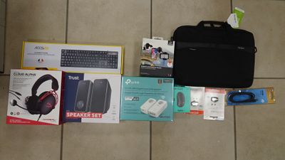 a laptop, headphones, a keyboard, a mouse, and other items laid out on the floor