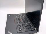 a laptop with a black keyboard on a white surface