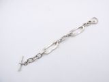 a close up of a silver bracelet with a cross on it