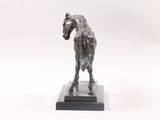 a statue of a horse that is standing on a base