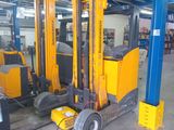 a forklift truck that is parked inside of a warehouse