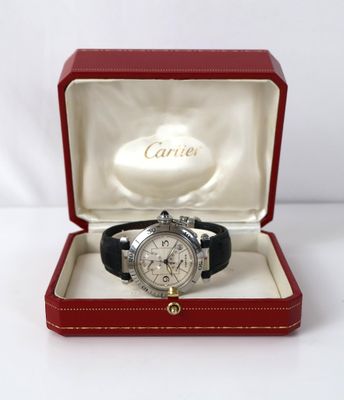 a close up of a watch in a red box on a white surface