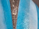 a close up of a statue of a person wearing a blue jacket
