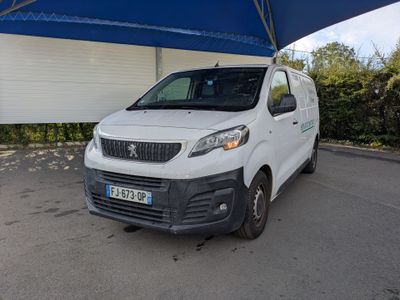 a white van that is parked under a blue umbrella
