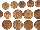 a close up of a bunch of coins on a white surface