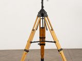an image of a telescope on a tripod on a wooden floor