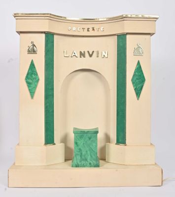 a small statue of a building with a green door