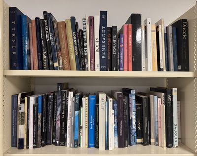 many books that are on the shelves in the room