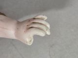 a toy hand that is sitting on a skateboard