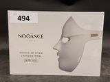 a box with a white mask on it on a table