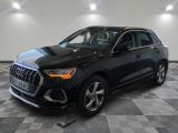 a black audi suv parked on a checkered floor in a showroom