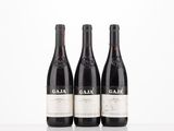 three bottles of wine sitting on top of a white table