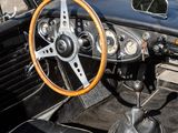 a black car with a wooden steering wheel and dashboard