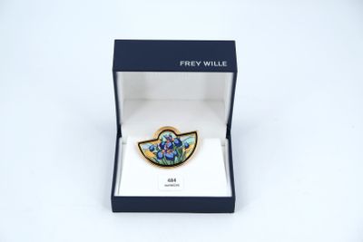 a close up of a blue and white broochle in a box