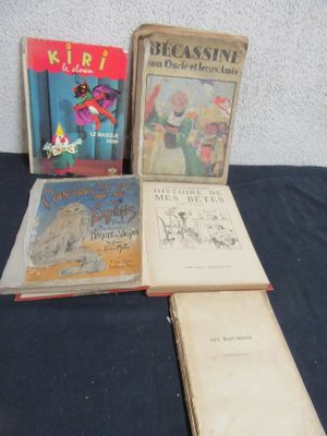 several children ' s books are sitting on a table with a blue table cloth