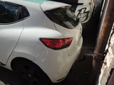 a white car parked in a parking lot next to other cars