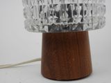 a table lamp with a wooden base and a clear glass shade