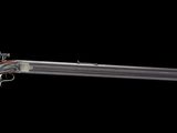 an old gun with a wooden barrel is shown against a black background