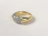 a close up of a gold and diamond ring on a white surface