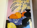 a box with a painting of oranges and lemons in it