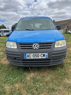 La voiture bleue est garée sur la pelouse devant une maison.