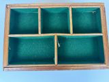 an old wooden box with four compartments on a blue background