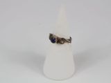 a close up of a ring on a white cone on a white surface