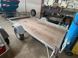 une remorque à laquelle est attelée une autre remorque, dans un garage