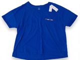 a blue t - shirt with a white tag on the chest