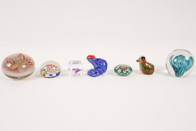 several glass birds are lined up in a row on a white surface