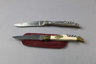 two knives that are sitting next to each other on a table