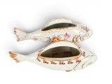 two fish shaped dishes sitting on top of each other
