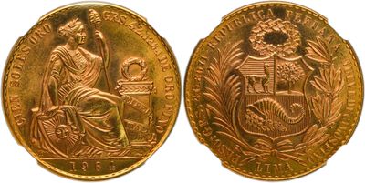 a gold coin with a woman sitting on top of it